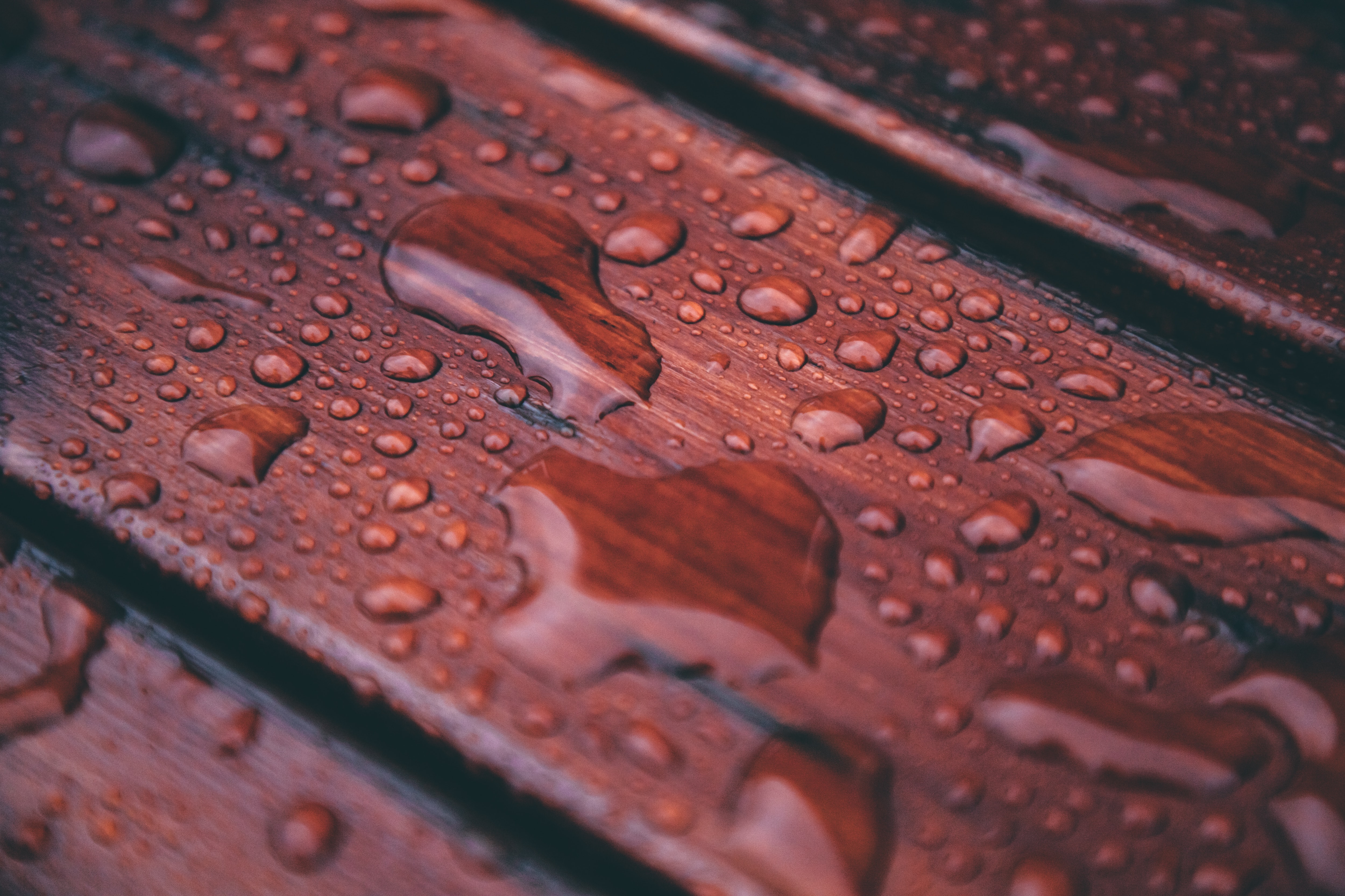 Water on stained, wooden clean decking